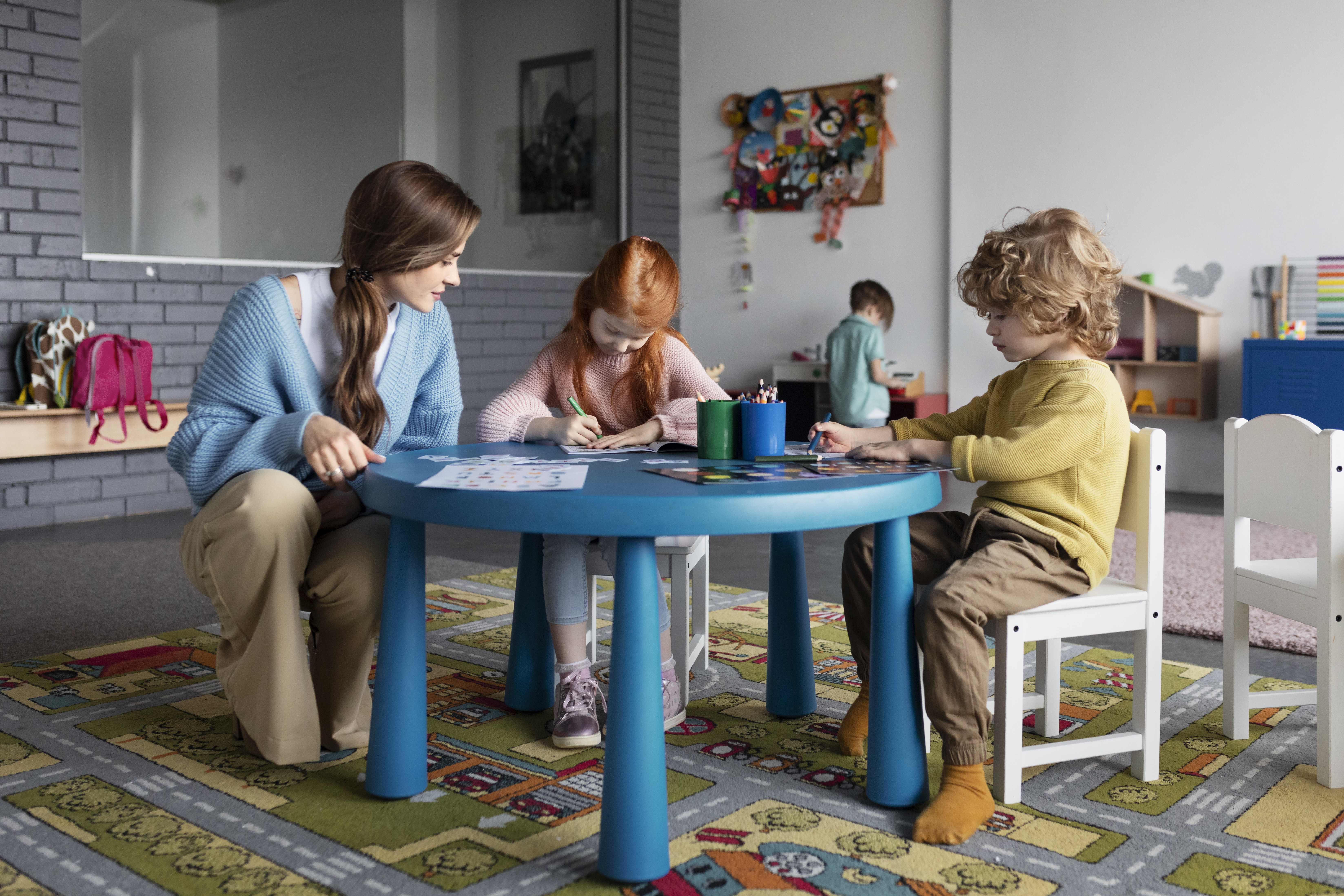 Children drawing together at a table