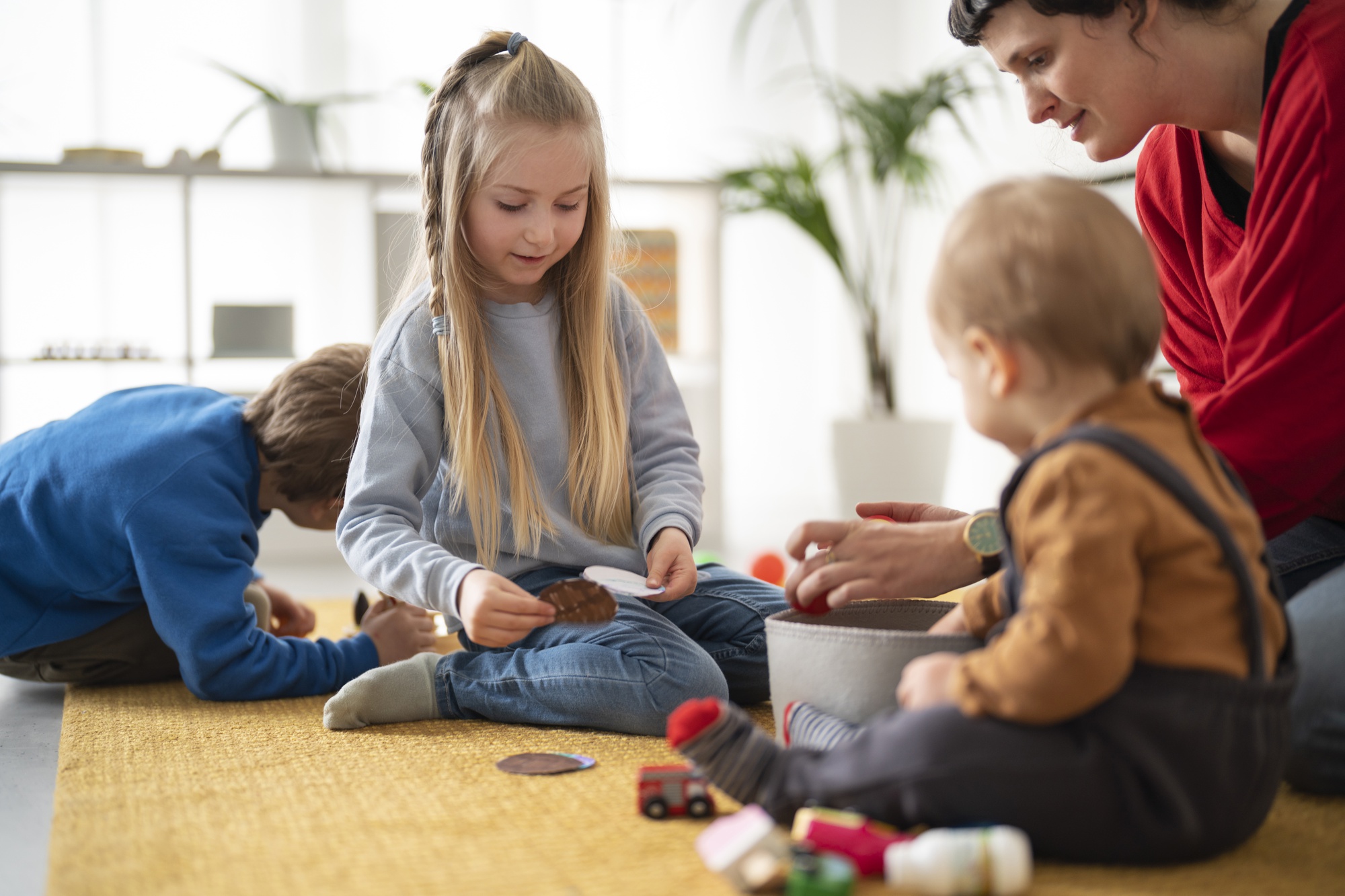 Childminder supervising children playing